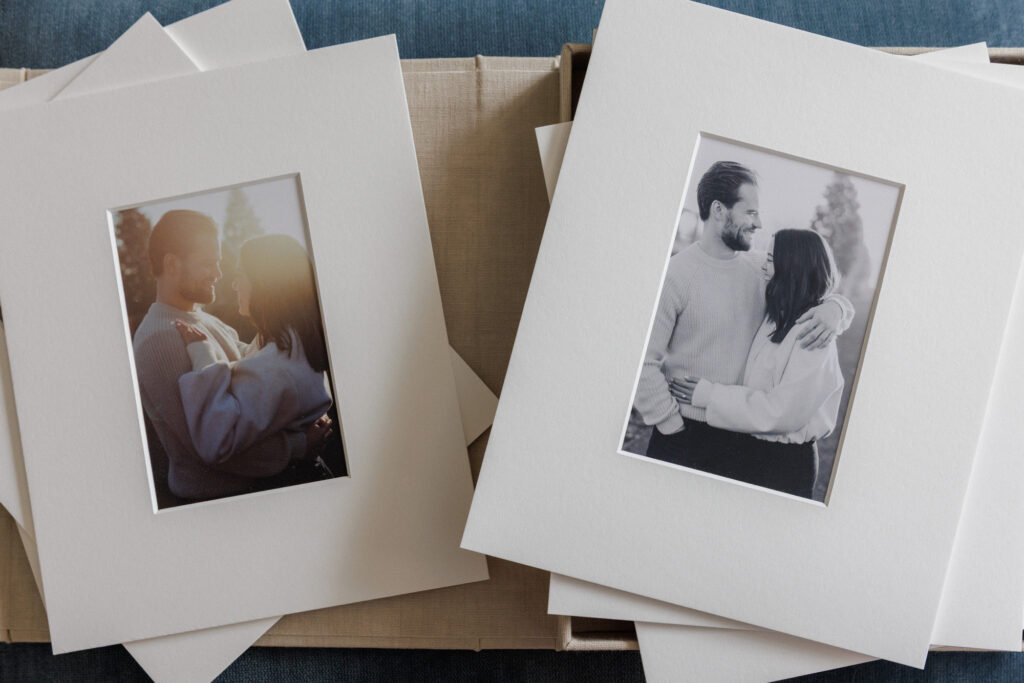 Matted engagement photos displayed outside of a linen box ready for framing