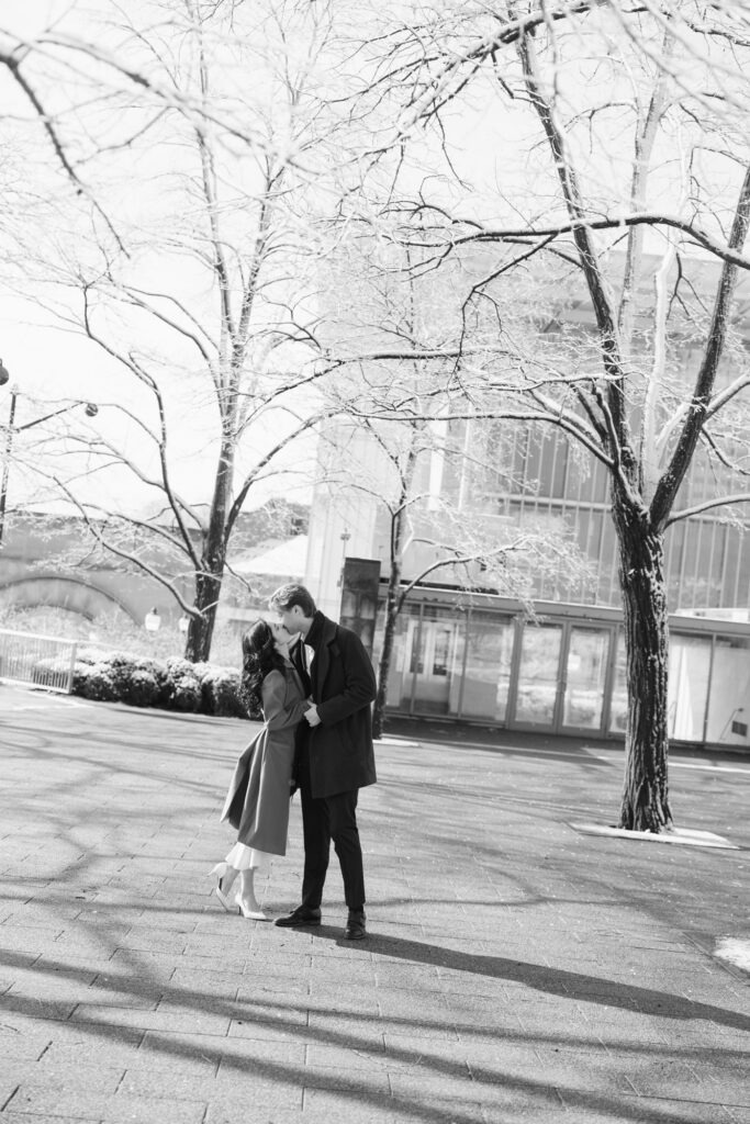 Black and white engagement photo in Chicago park with couple under trees