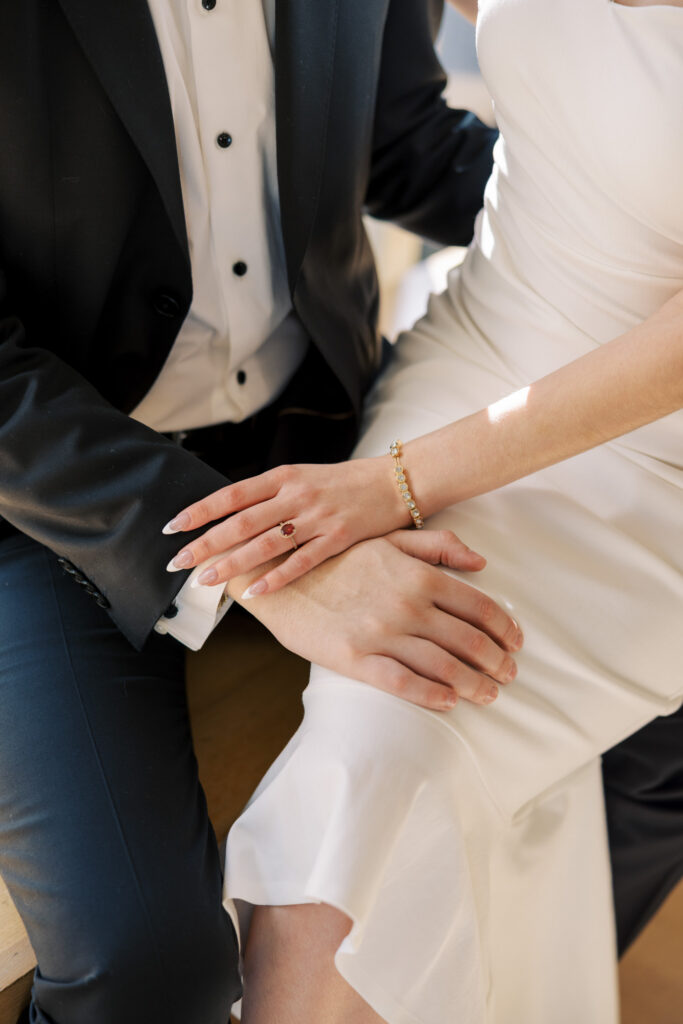 Close up engagement photo holding hands with ring detail