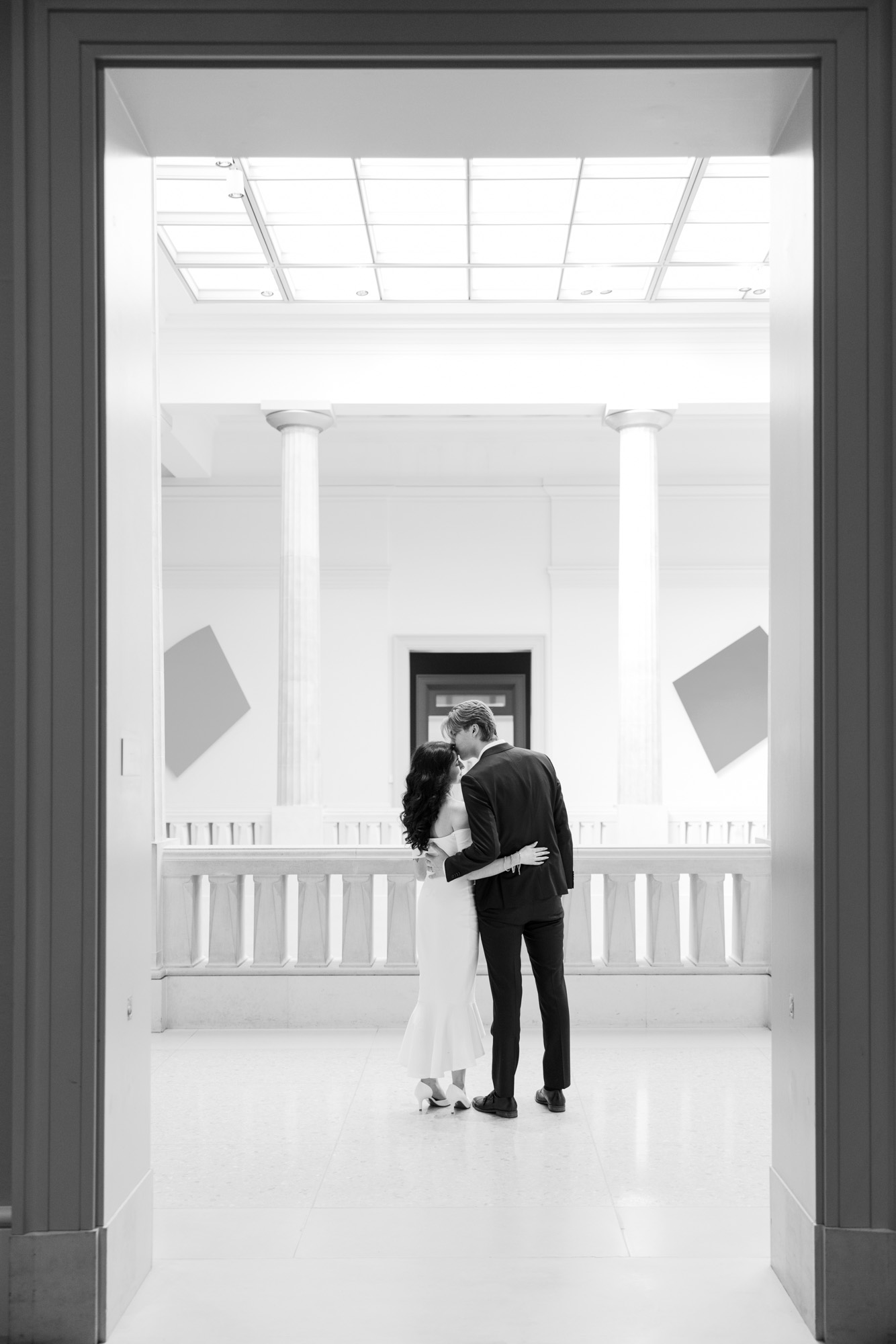 Art Institute Chicago engagement photos couple embracing in gallery with columns
