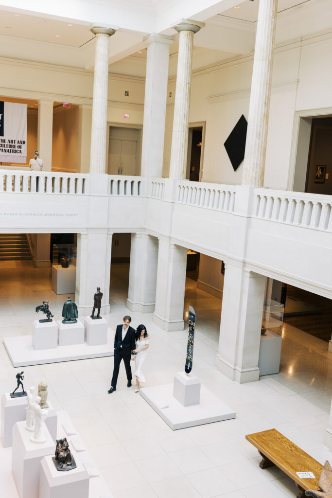 Art Institute Chicago grand hall engagement photo with sculptures and columns