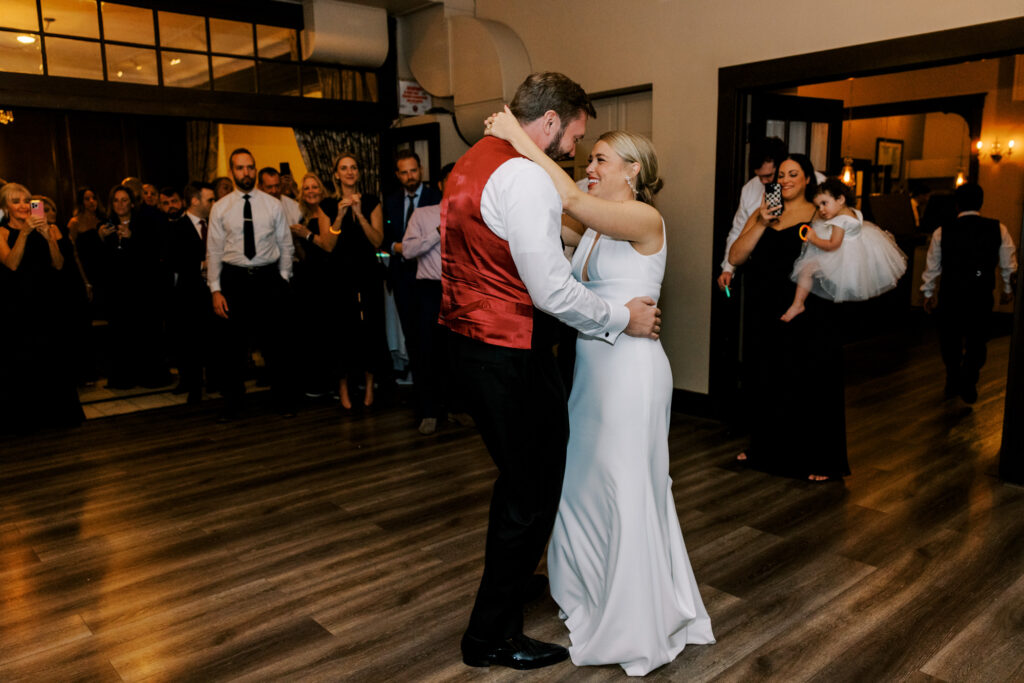 Bride And Groom Dancing Surrounded By Guests