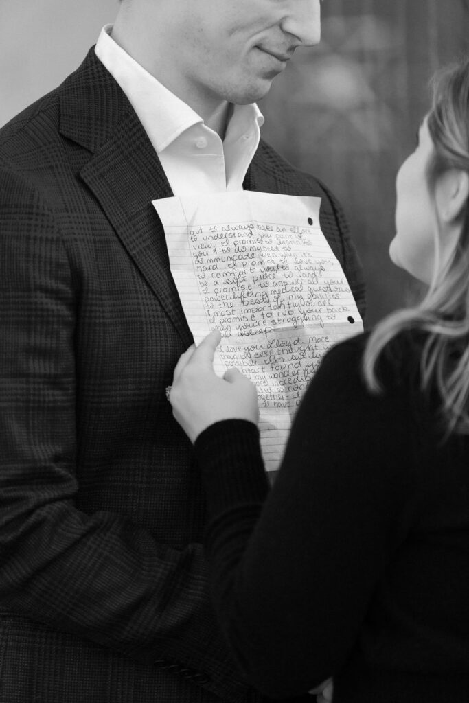 Bride holding handwritten vows during private vow reading