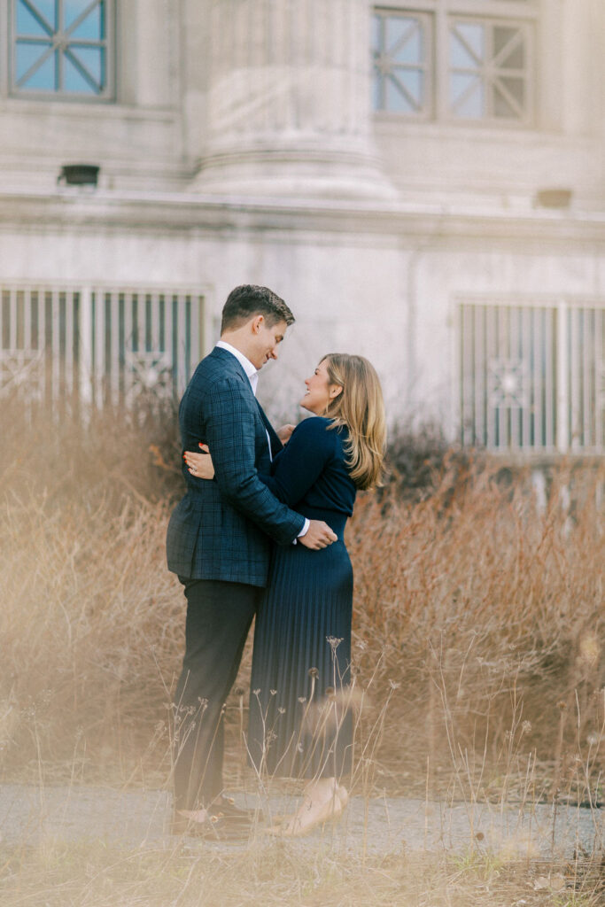 Couple embracing in tall grass near Museum Campus