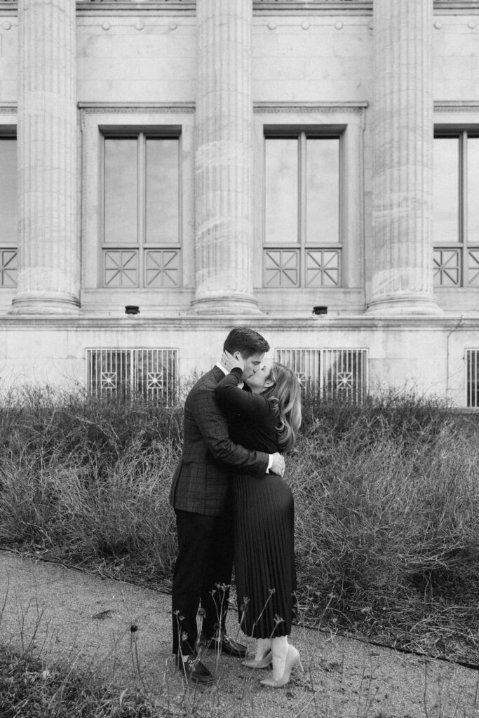 Couple embracing in front of classical architecture in Chicago