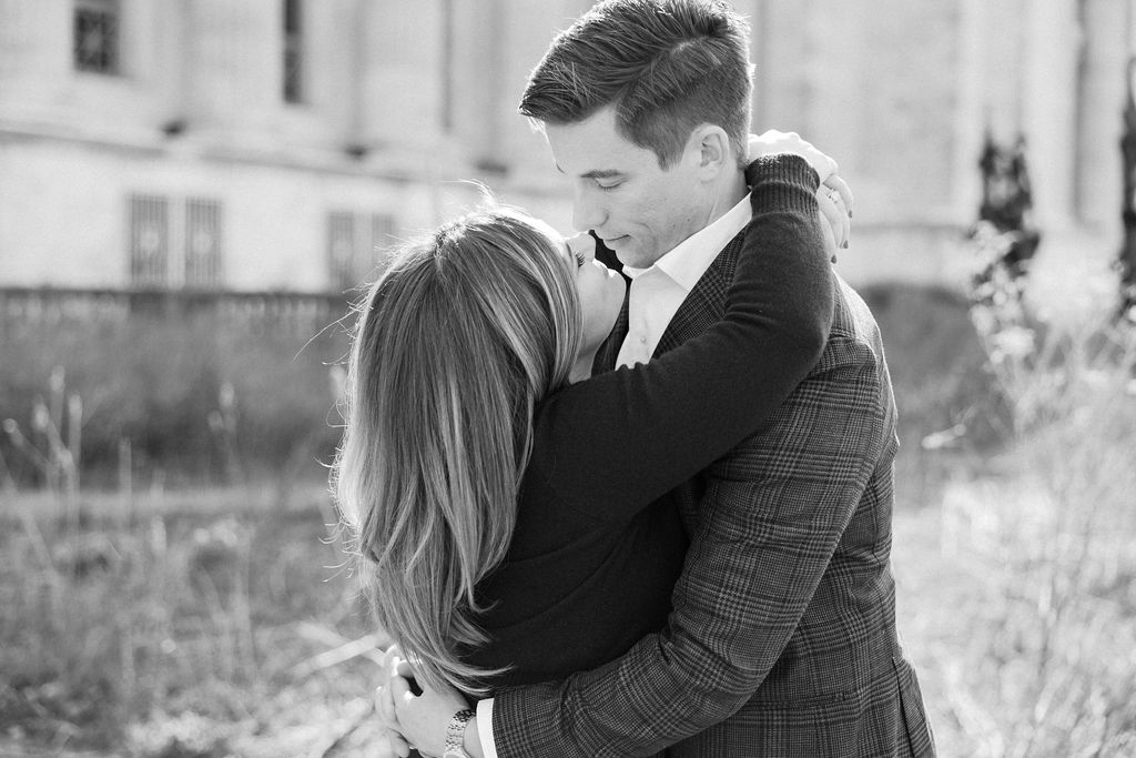 Couple embracing in front of classical architecture in Chicago