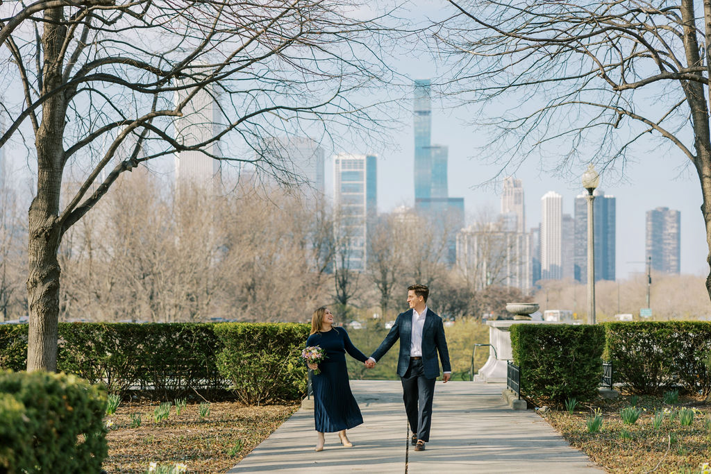 Couple walking at Museum Campus with Chicago skyline in background