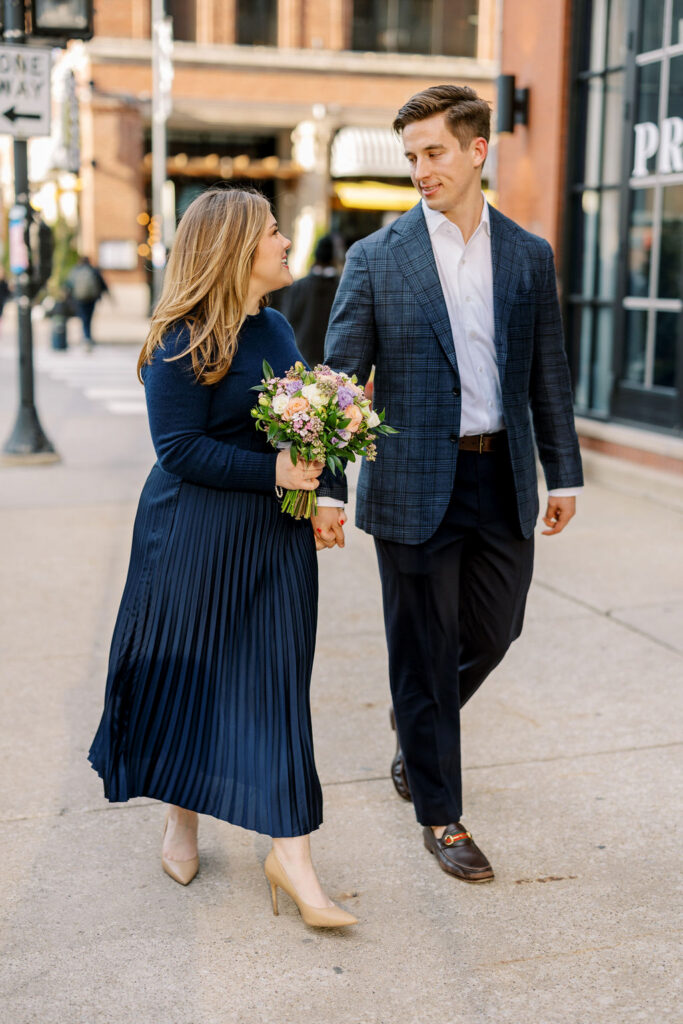 Couple walking together along Chicago sidewalk