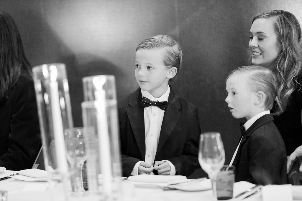 Guests seated at candlelit dinner table during ceremony