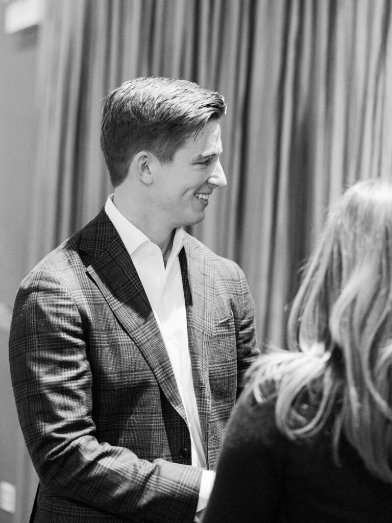 Groom smiling during wedding ceremony at Sepia
