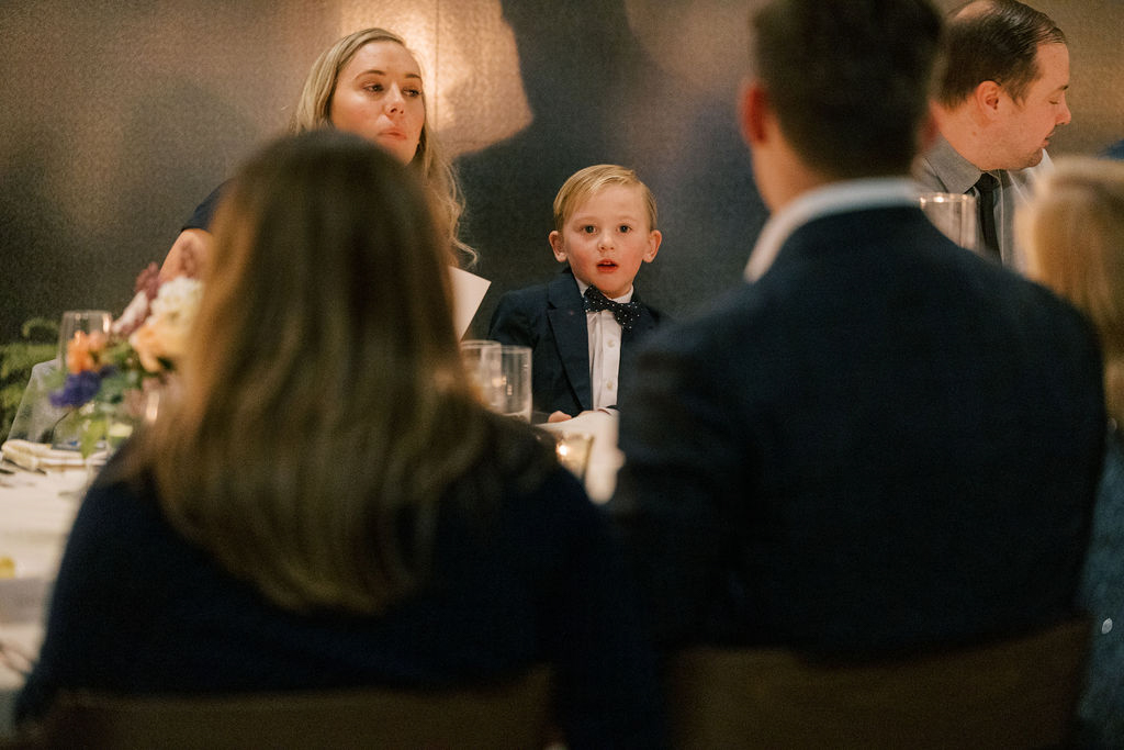 Guests reacting and smiling during dinner speeches