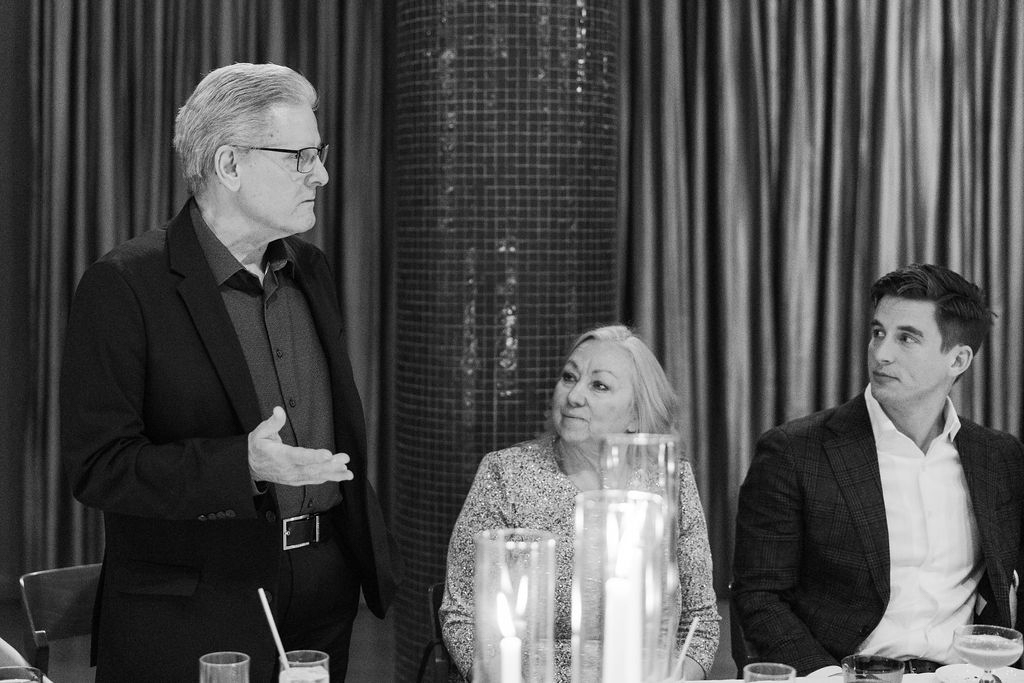 Guests reacting and smiling during dinner speeches