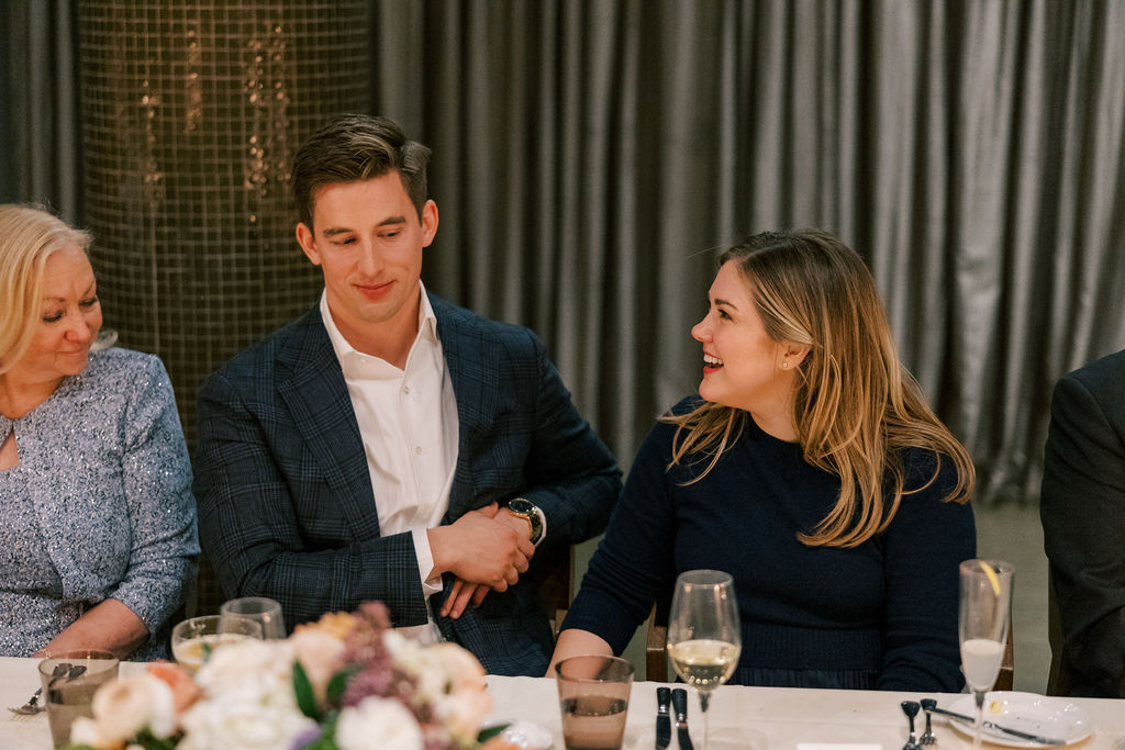 Guests reacting and smiling during dinner speeches