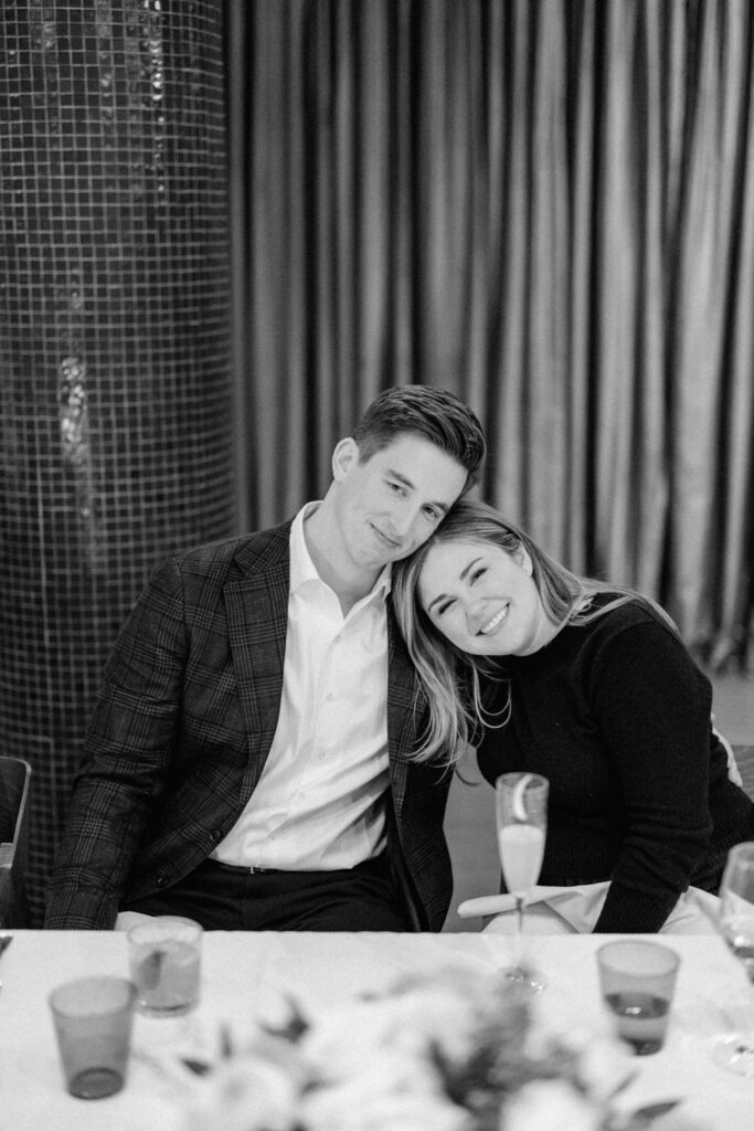 Black and white portrait of couple seated together at dinner table