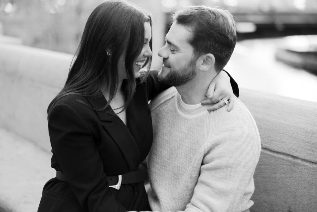 Couple Sitting Together Along Chicago River Engagement Photos