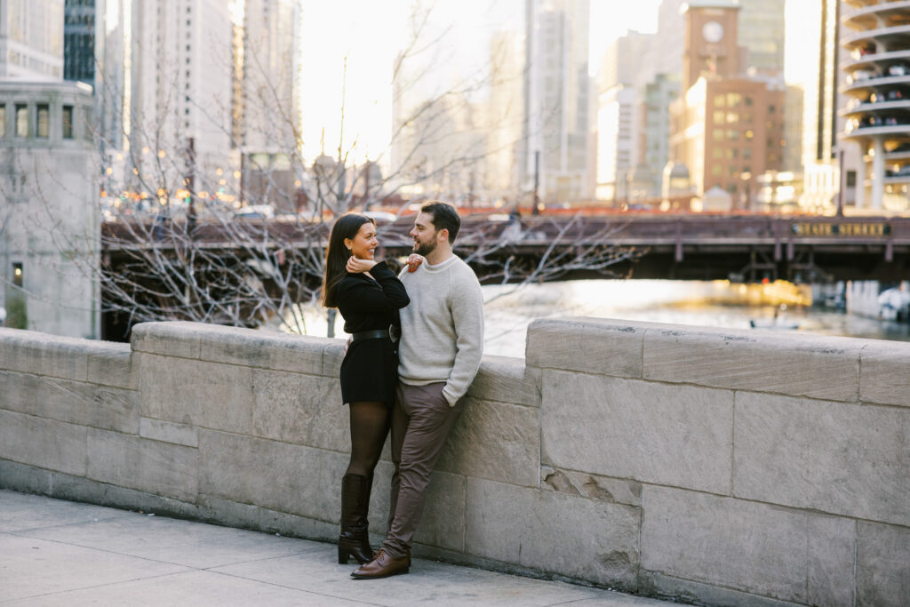 Couple Standing By Chicago River Bridge At Dusk Engagement Photos