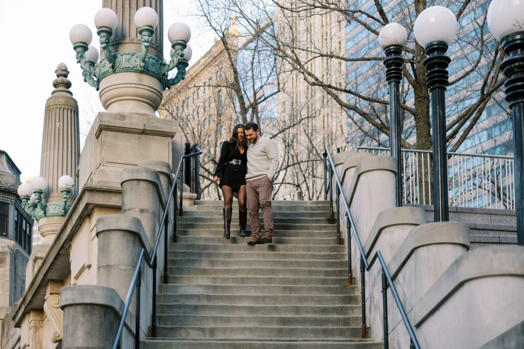 Couple Walking Down Chicago Riverwalk Stairs Engagement Photos
