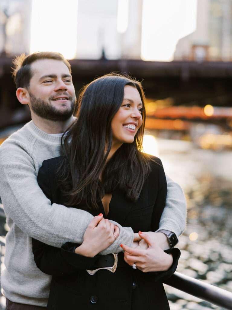 Candid Engagement Photo Couple Laughing Together By River
