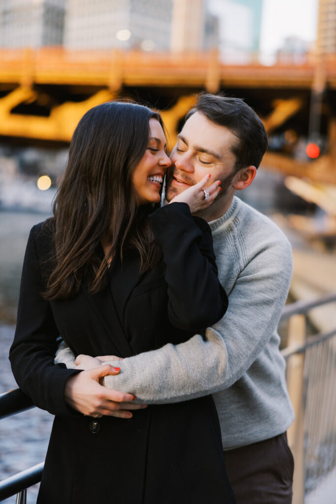 Couple Embracing By Chicago River At Sunset Engagement Session