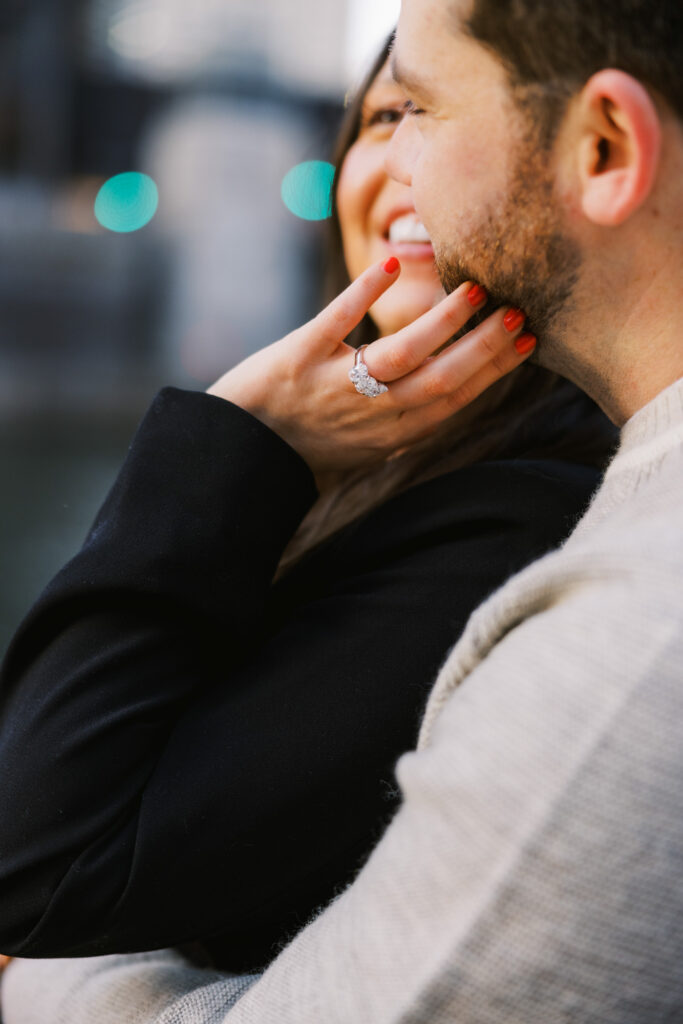 Close Up Engagement Photo Woman Smiling With Hand On Face