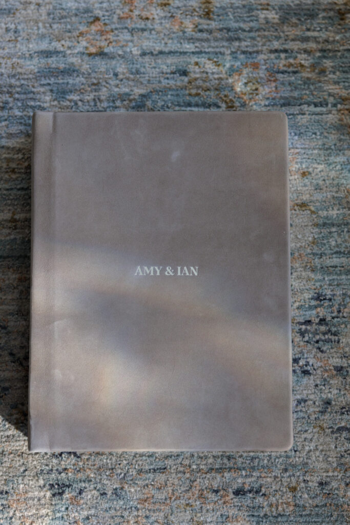Custom wedding album with soft linen cover and embossed names Amy and Ian