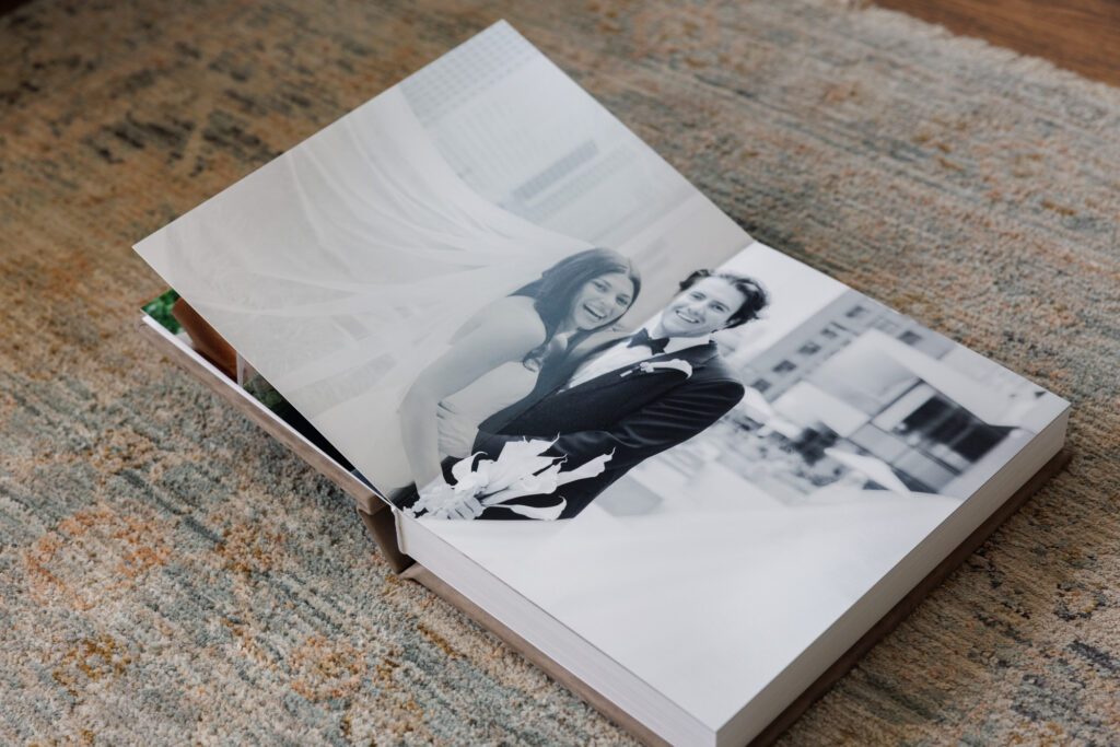 Full bleed black and white bridal portrait displayed in a fine art wedding album