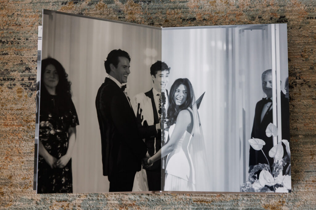Black and white wedding ceremony moments displayed across a minimalist album spread