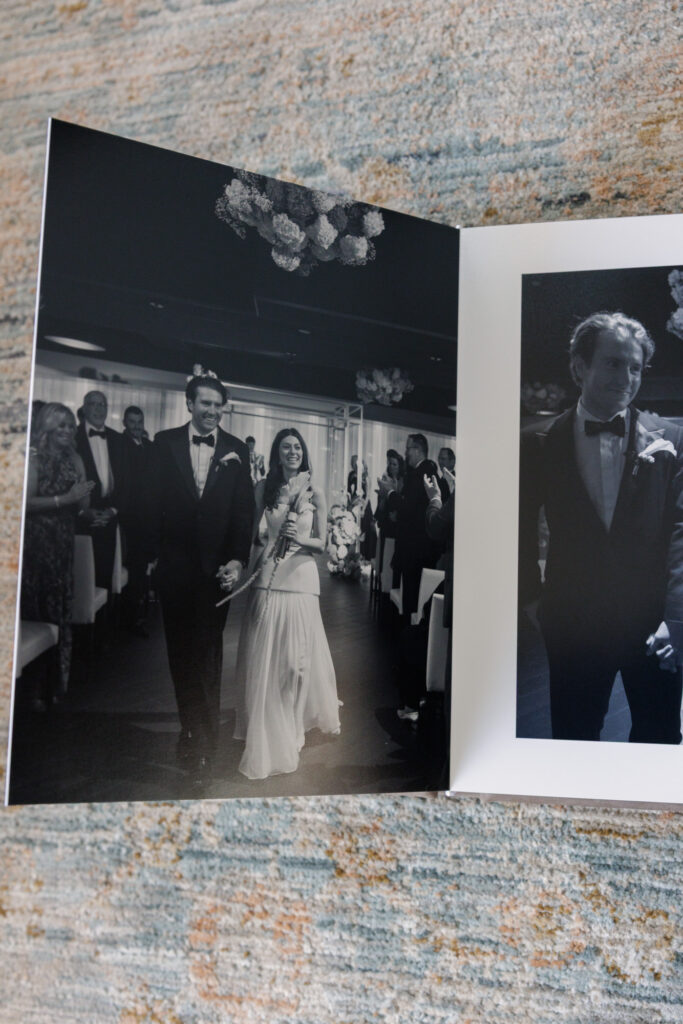 Black and white wedding ceremony moments displayed across a minimalist album spread