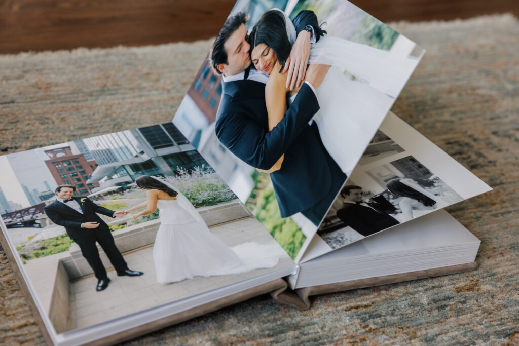 Lay flat wedding album open to a full color portrait spread of bride and groom embracing
