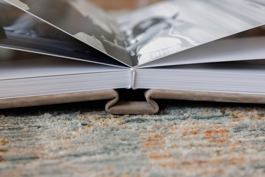 Close up of lay flat wedding album binding showing thick pages and seamless gutter detail