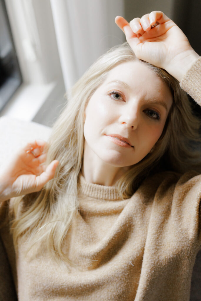 Cozy sweater boudoir session with soft window light